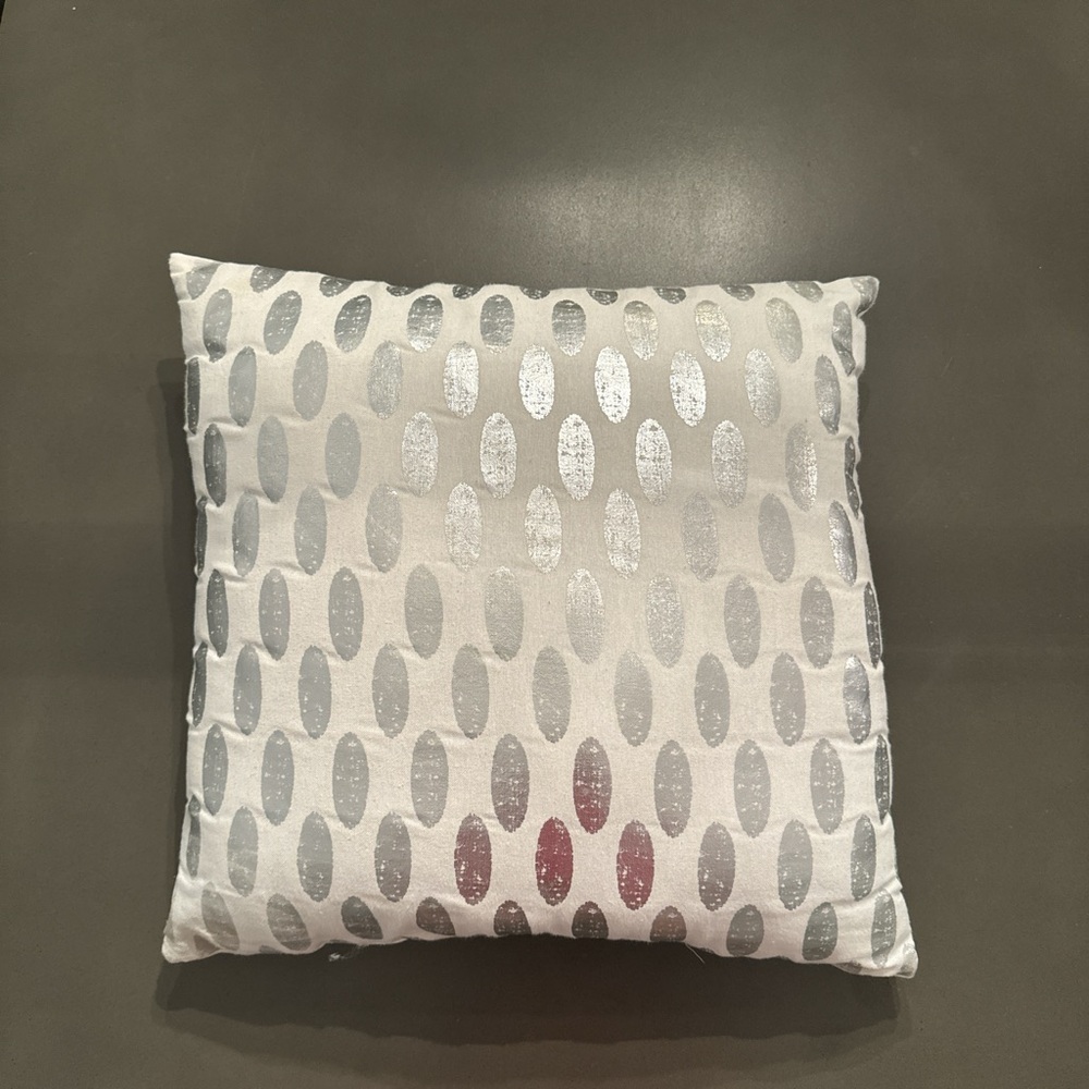 White and silver cushion throw pillow.